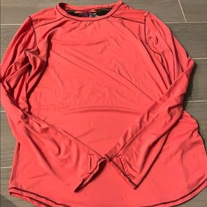 Pink long sleeve shirt with thumb slots.